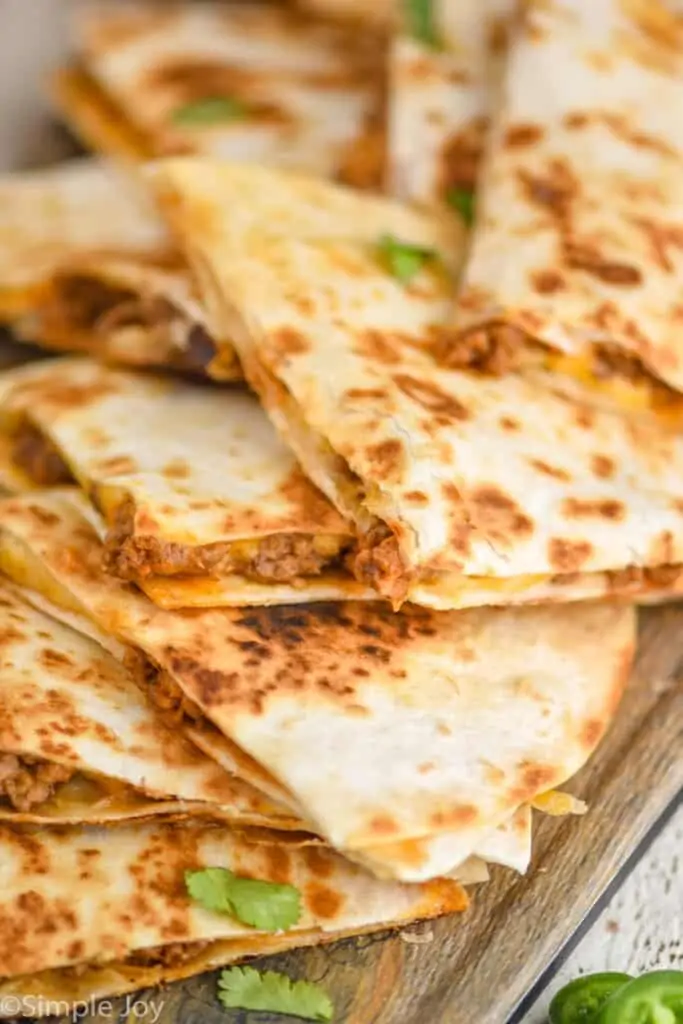 close up of a pile of beef quesadillas