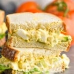 an egg salad sandwich that has been cut in half and stacked - 19