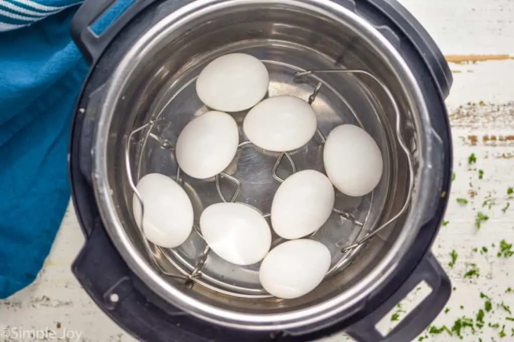 overhead view of eggs in an instant pot, with the steamer basket inside