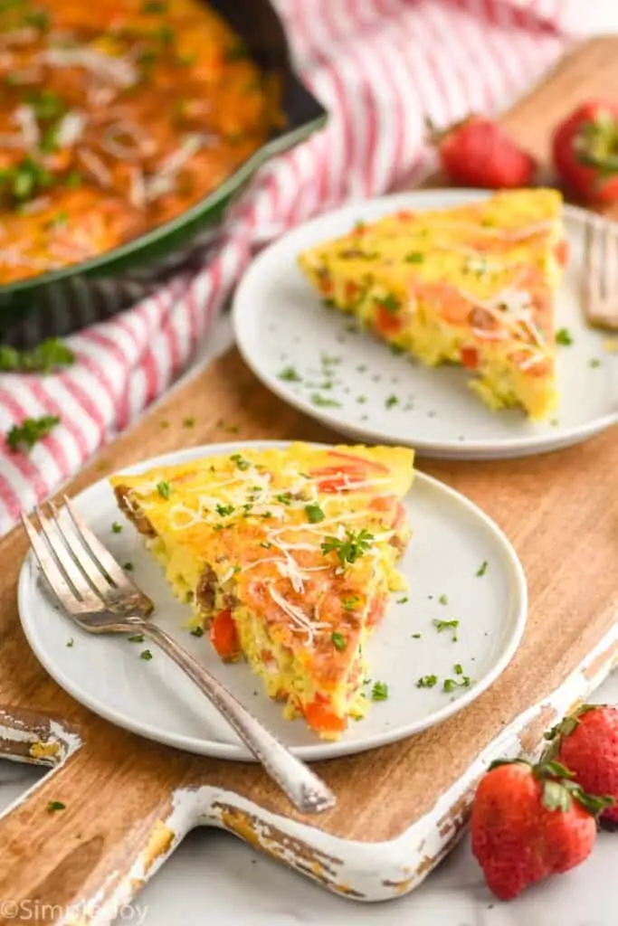 two pieces of frittata on small plates garnished with parsley