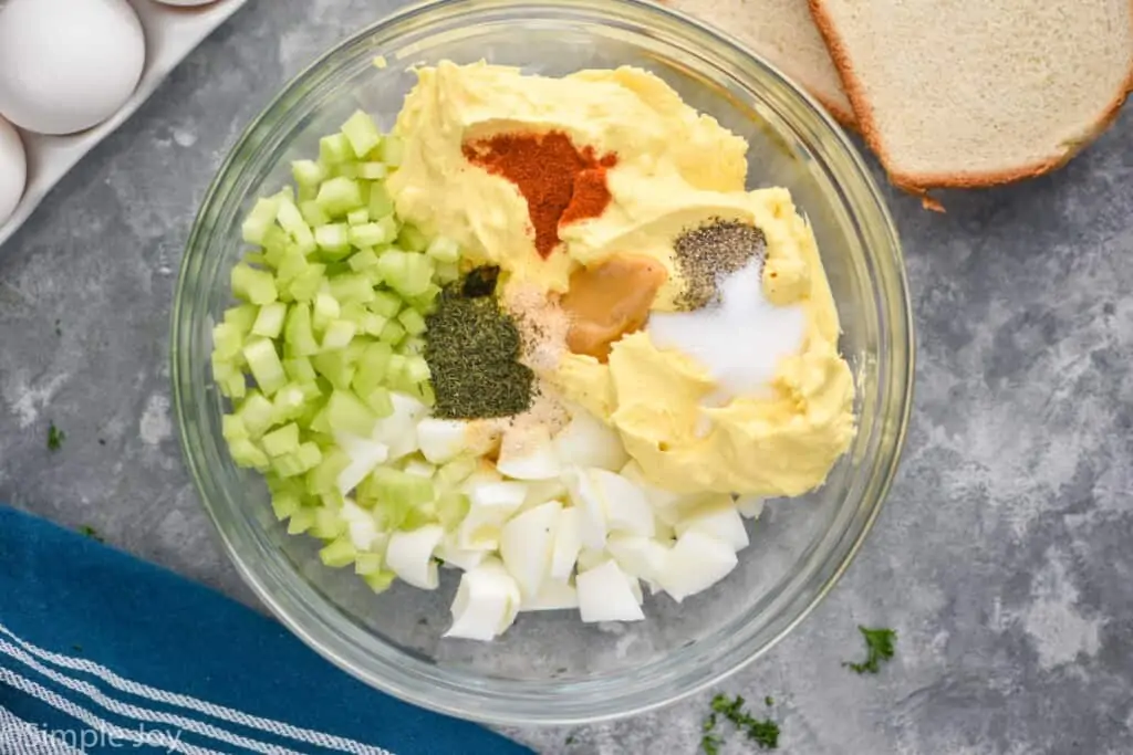 overhead picture of a bowl of the ingredients for egg salad