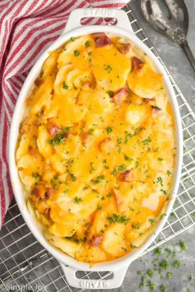 overhead of a white casserole dish with scalloped potatoes and ham recipe