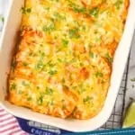 pinterest graphic of overhead view of a baking dish full of chicken enchiladas garnished with cilantro