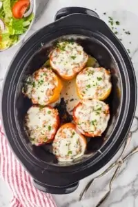 overhead photo of six stuffed peppers in a crockpot