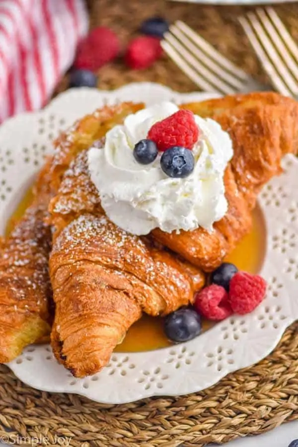 croissant French toast topped with whipped cream and berries