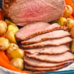pinterest graphic of eye round roast on a platter that has been sliced