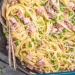 pinterest graphic of overhead close up view of ham and pea pasta in a skillet garnished with freshly grated parmesan cheese