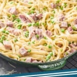pinterest graphic of side view of a skillet full of ham and pea pasta recipe