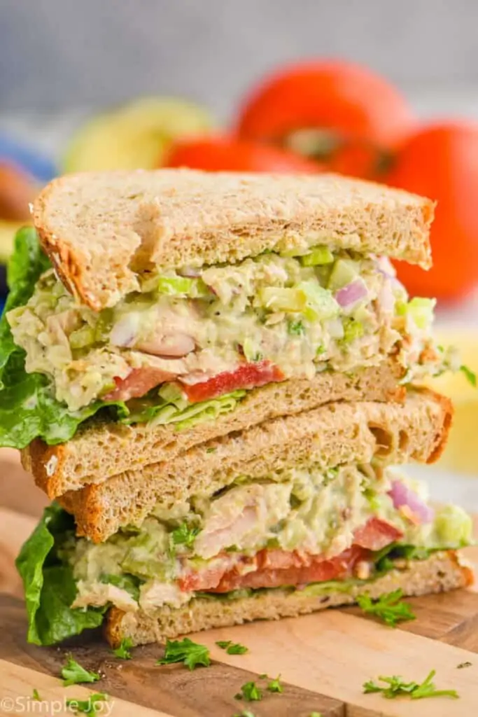 two half avocado tuna salads stacked on top of each other