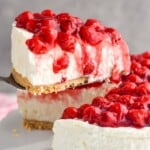 piece of cherry cheesecake being lifted out of a cheesecake - 8
