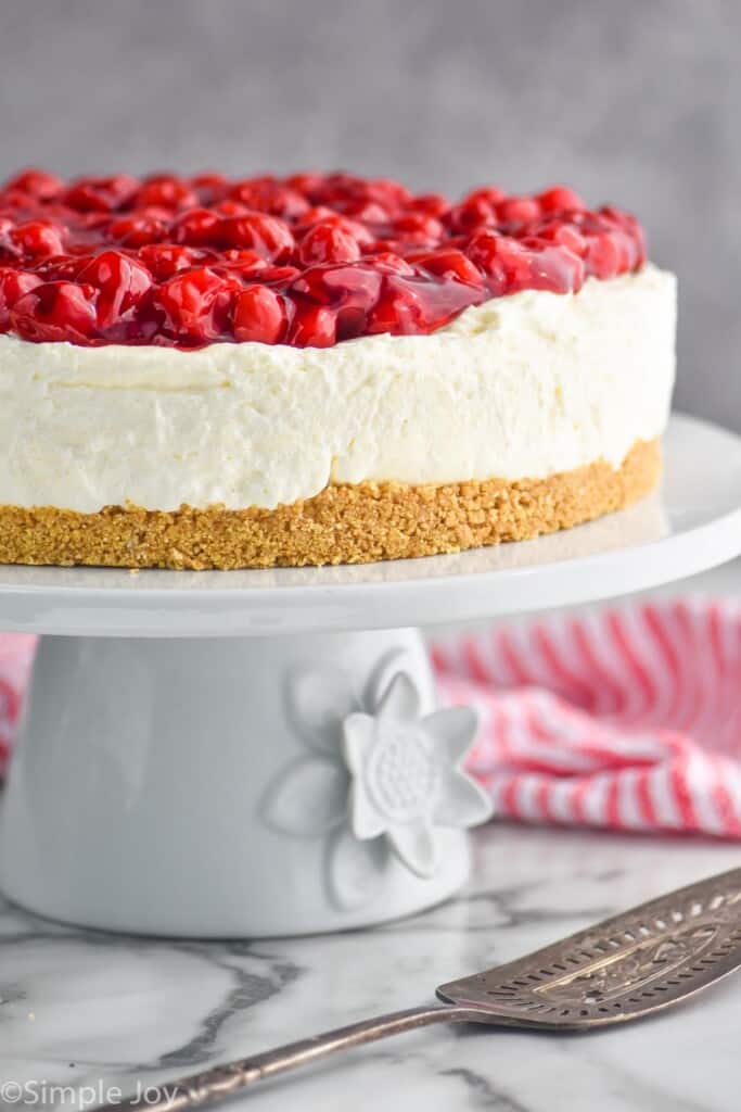 cherry cheesecake recipe on a cake stand