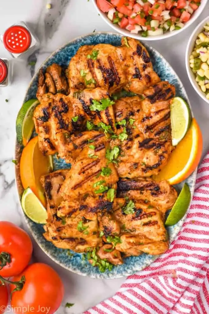 overhead of platter of grilled chicken thighs to make street tacos