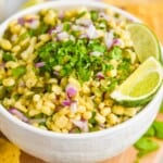 a white bowl full of chipotle corn salsa topped with extra cilantro - 13