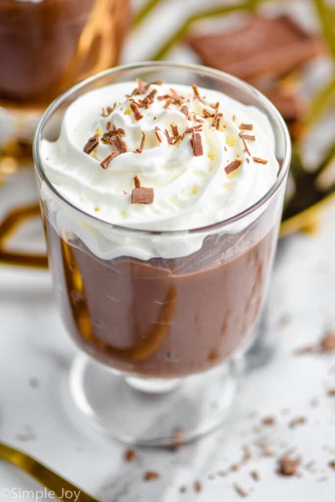 chocolate pudding recipe in a cup topped with whipped cream