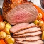eye round roast on a platter that has been sliced
