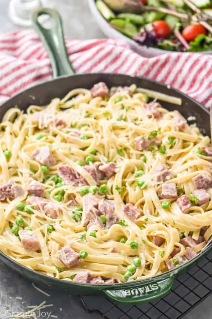 side view of a skillet full of ham and pea pasta recipe