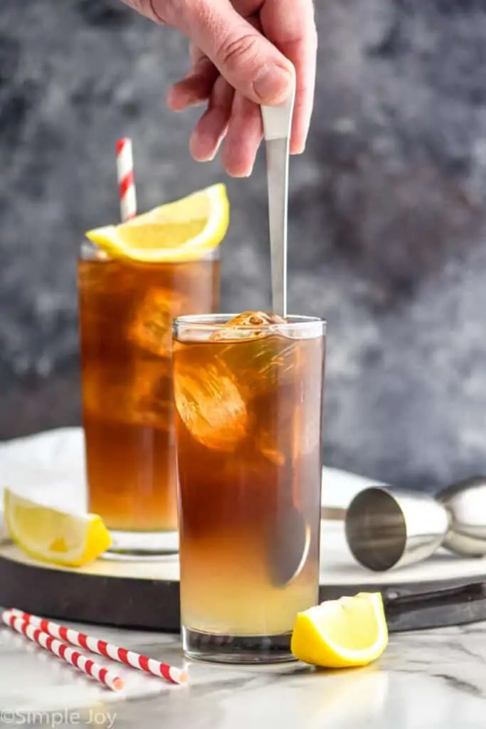 stirring a cocktail in a high ball glass