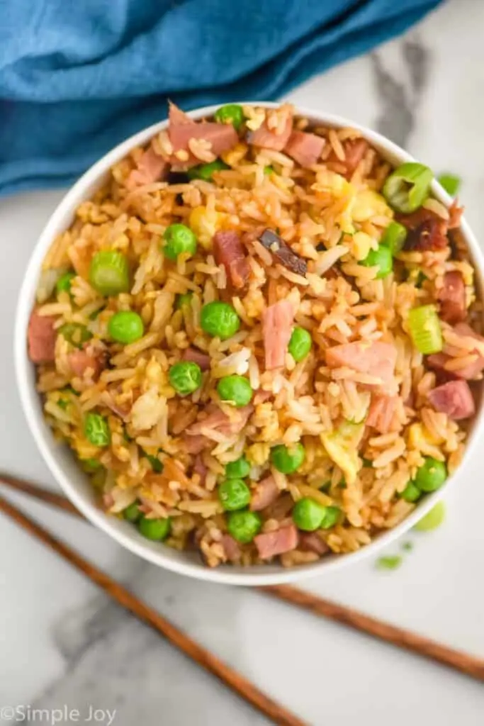 overhead of a bowl of fried rice with ham in it