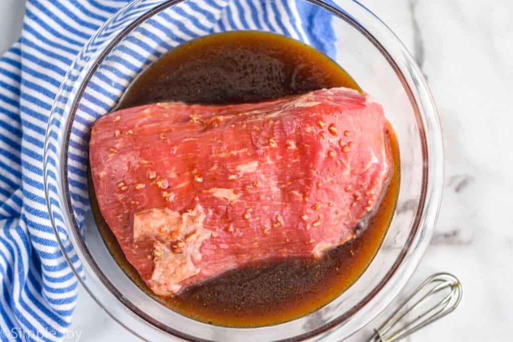 overhead view of a piece of beef in marinade
