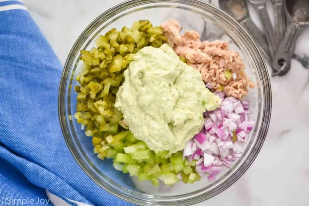 overhead of a bowl of avocado tuna salad separated by ingredient