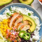 pinterest graphic of overhead of a burrito bowl with chicken, rice, avocado, beans, salsa, and corn