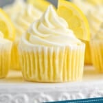 pinterest graphic of up close picture of lemon cupcakes topped with frosting swirl and a lemon wedge