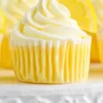 pinterest graphic of up close picture of lemon cupcakes topped with frosting swirl and a lemon wedge