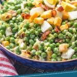 pinterest graphic of side view of pea salad with pieces of hard boiled egg, cubed cheese, and bacon on top