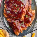 pinterest graphic of overhead of slow cooker ribs on a platter