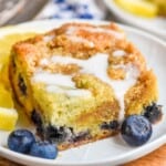 a piece of blueberry coffee cake on a plate with a drizzle of icing on top - 9