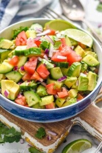 bowl full of cucumber tomato avocado salad