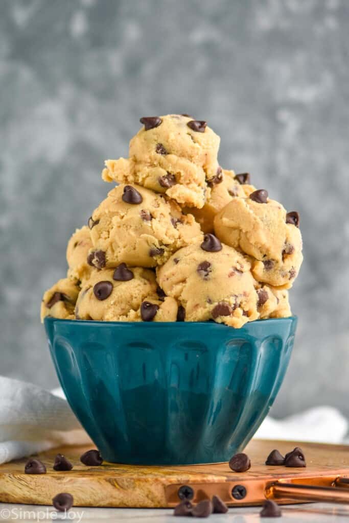 a large blue bowl with lots of scoops of chocolate chip cookie dough