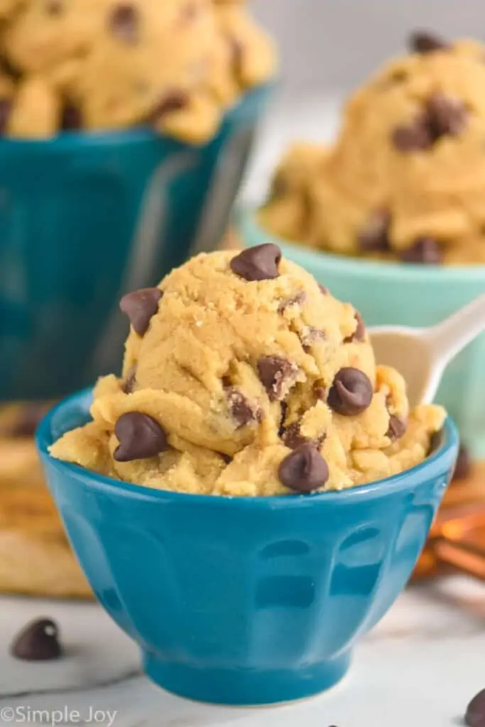 a close up of edible cookie dough recipe in a small blue bowl