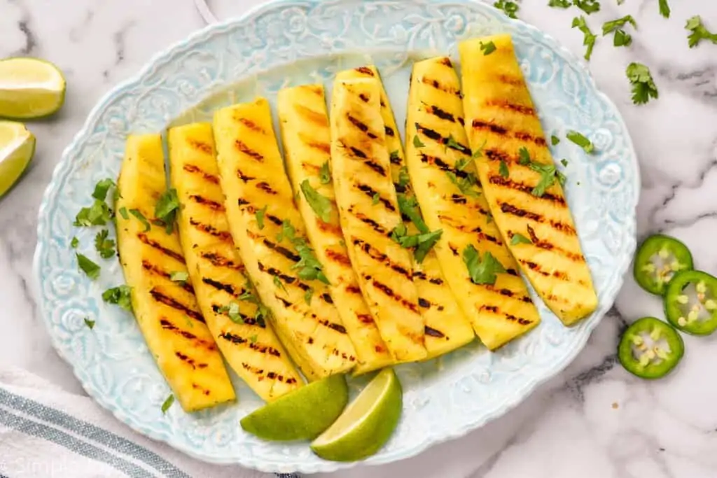 a platter with wedges of grilled pineapple
