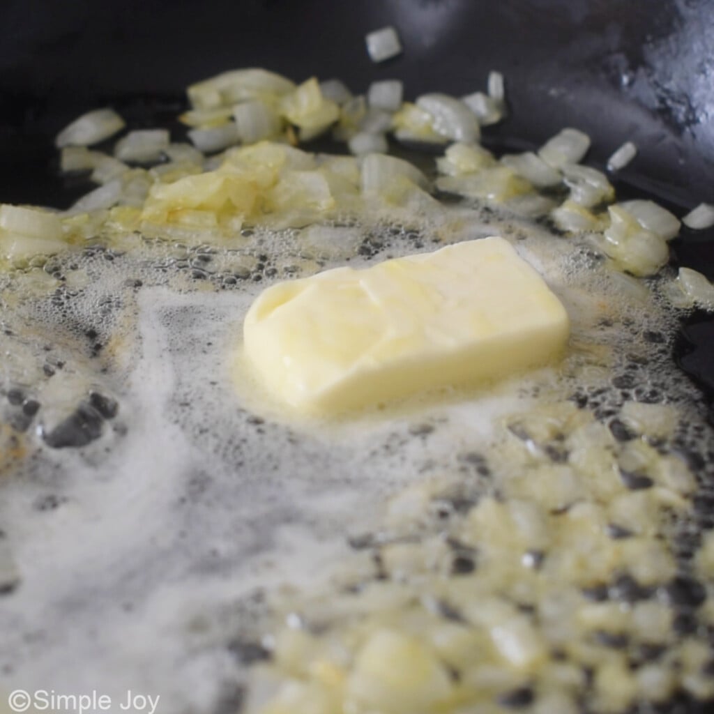 butter melting in a skillet with onions