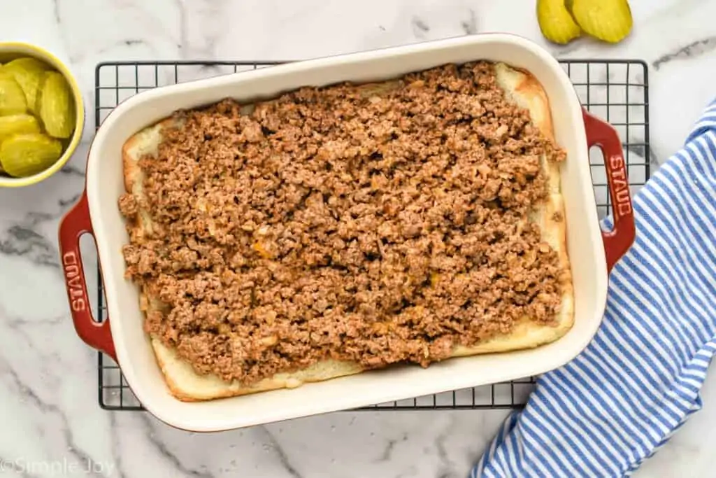 overhead of a pan of with the bottom of rolls and ground beef on top