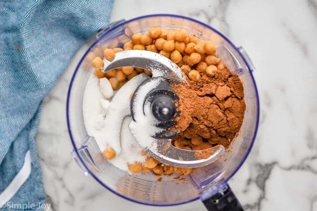 overhead of the ingredients to make chocolate hummus in a food processor