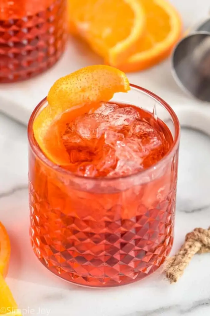 tumbler with a Negroni garnished with an orange peel