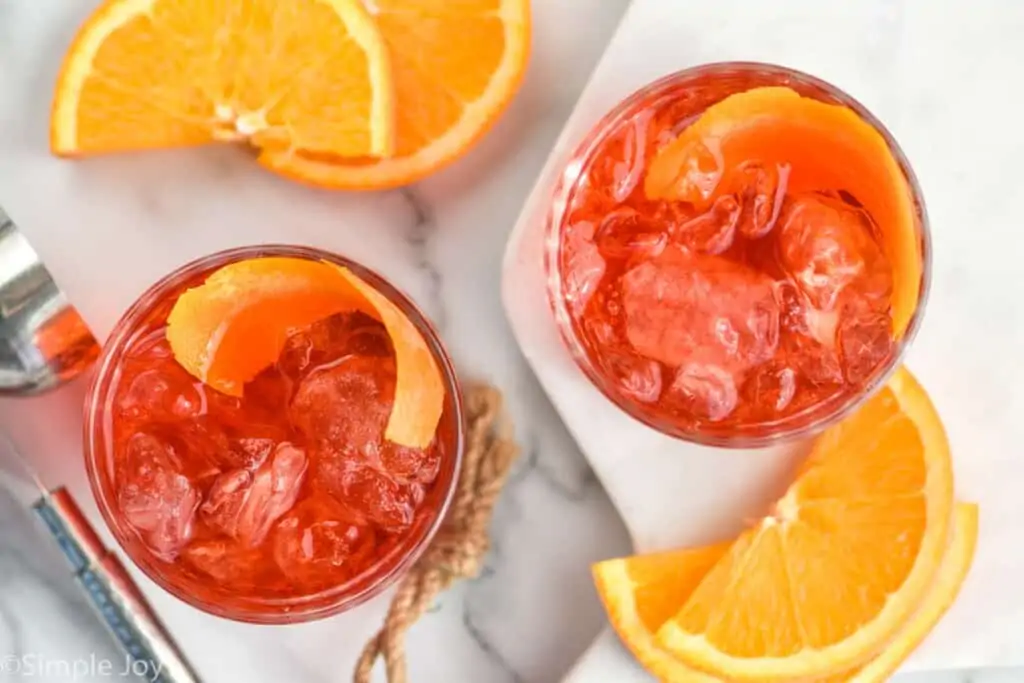 overhead of two tumblers full of Negroni cocktail