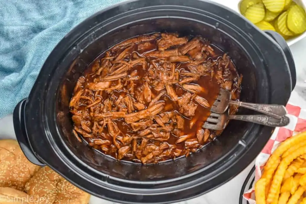 overhead of pulled pork in a crock pot