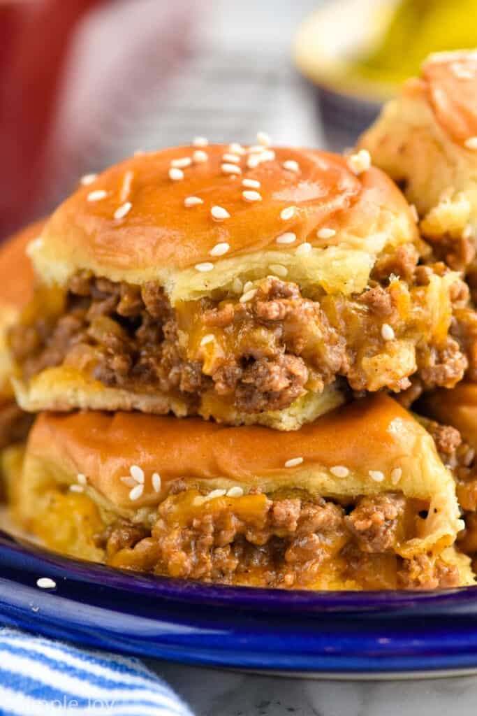 two cheeseburger sliders stacked one on top of the other