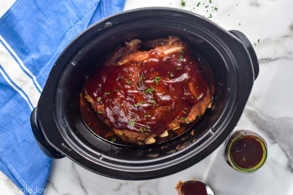 over head of crock pot ribs in a slow cooker