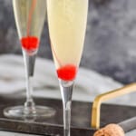 pinterest graphic of champagne being poured into a flute to top off a French 76 recipe
