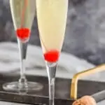 pinterest graphic of champagne being poured into a flute to top off a French 76 recipe
