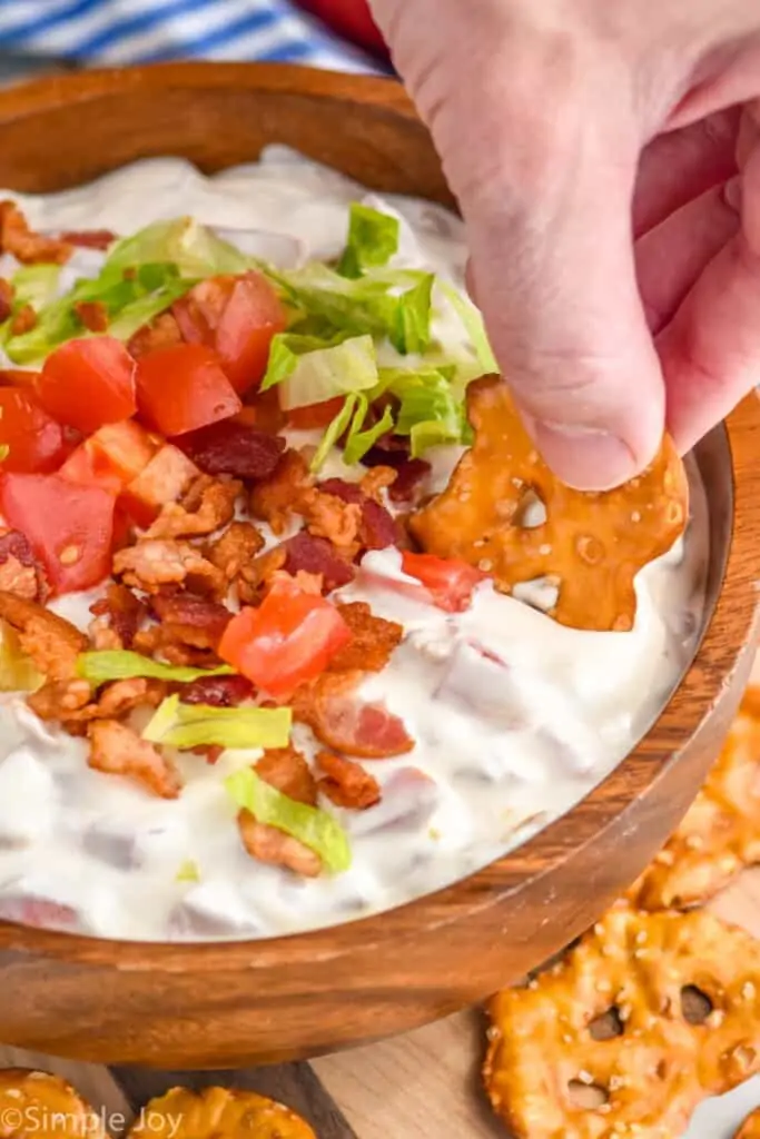 dipping a pretzel flat into dip