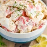 pinterest graphic showing side view of a bowl of crab salad garnished with fresh dill
