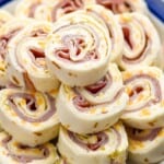 close up of ham and cheese roll ups on a plate - 19
