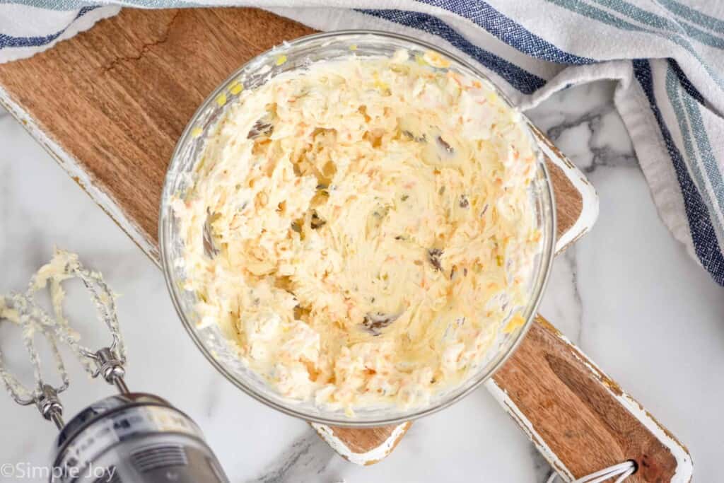 overhead of a bowl of cream cheese mixture with cheese and relish