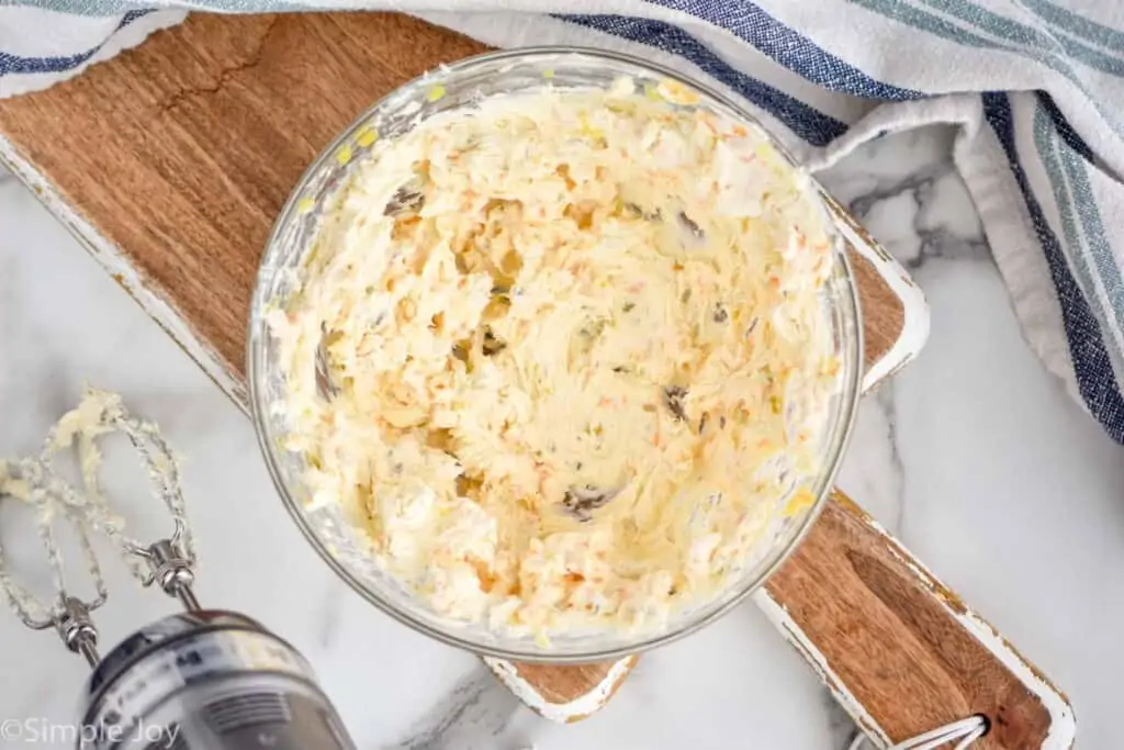 overhead of a bowl of cream cheese mixture with cheese and relish