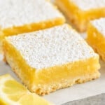 a close up of a lemon bar on parchment paper - 10